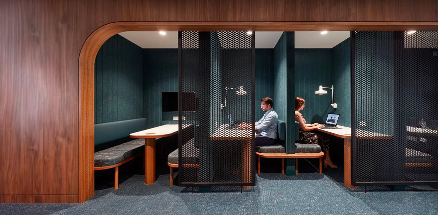 Modern office space with private office booths and employees working.